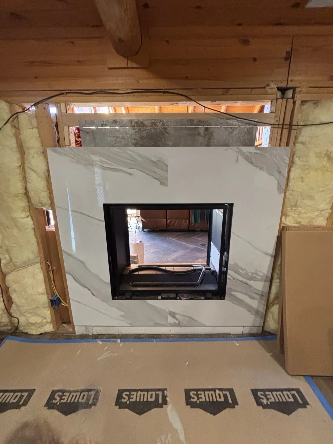 Large format marble-look tile fireplace surround in progress