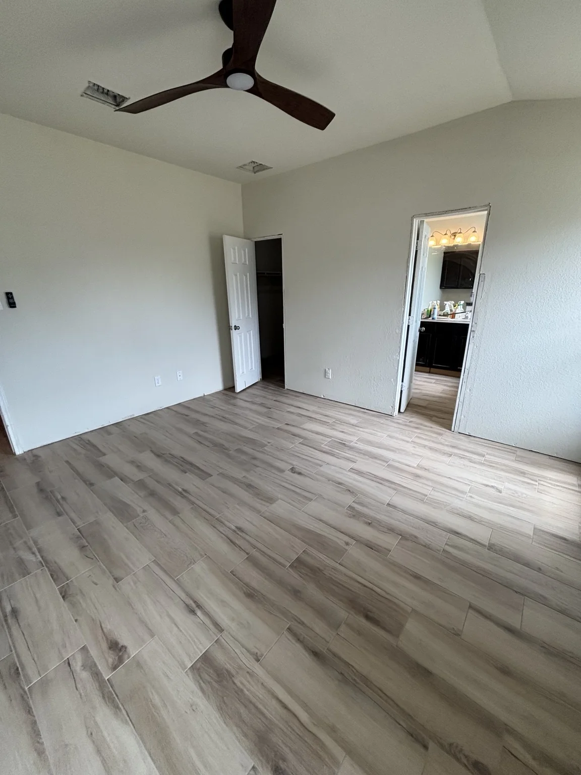 Completed light wood-look flooring across a residential room